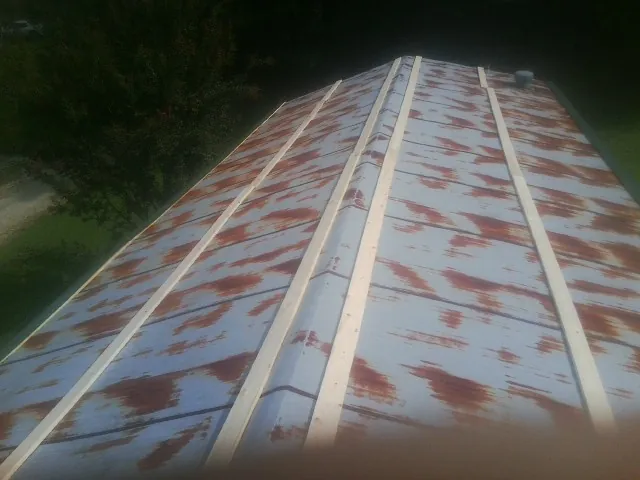 Rusted metal roof panels with new wood purlins before replacement — Storm Damage Roof Repair in Fanwood by Roofing Brothers