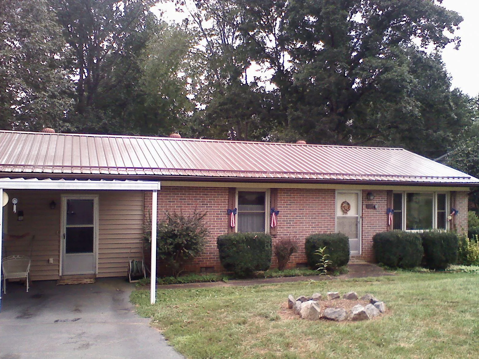 Bronze metal roof and carport on a brick ranch home — Roof Repair work by our crew in Fanwood